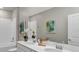 Bathroom with double vanity, white cabinets, and a large mirror at 3129 Zuni Rd, St Cloud, FL 34771