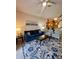 Living room with blue sofa and striped armchairs, open to kitchen at 606 Gran Bahama Boulevard # 29-606, Davenport, FL 33897