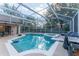 Relaxing pool and spa area with covered patio and grill at 7924 Bridgestone Dr, Orlando, FL 32835