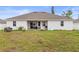 Large backyard with patio and grassy area at 840 S Palm Ave, Frostproof, FL 33843