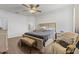 Spacious bedroom with large bed, dresser, and ceiling fan at 840 S Palm Ave, Frostproof, FL 33843
