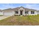 Single-story house featuring a neutral color palette and neat lawn at 840 S Palm Ave, Frostproof, FL 33843