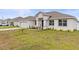 House exterior showcasing a light-colored facade and neatly landscaped yard at 840 S Palm Ave, Frostproof, FL 33843