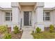 Inviting front entry with dark gray door and welcoming decor at 840 S Palm Ave, Frostproof, FL 33843