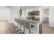 Modern kitchen with breakfast bar, stainless steel appliances, and granite countertops at 840 S Palm Ave, Frostproof, FL 33843