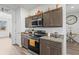 Modern kitchen with stainless steel appliances and dark wood cabinets at 840 S Palm Ave, Frostproof, FL 33843