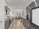 Eat-in kitchen with stainless steel appliances and hardwood floors at 840 S Palm Ave, Frostproof, FL 33843