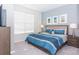 King-size bedroom with window and nightstands at 1534 Carey Palm Cir, Kissimmee, FL 34747