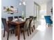 Bright dining room with wooden table, six chairs, and entryway view at 1534 Carey Palm Cir, Kissimmee, FL 34747