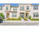 Tan two-story townhome with a front entry and landscaping at 1534 Carey Palm Cir, Kissimmee, FL 34747
