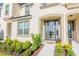 Townhome entrance with gray door, landscaping, and walkway at 1534 Carey Palm Cir, Kissimmee, FL 34747