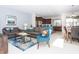 Open living space with gray sofas, blue armchair, and kitchen views at 1534 Carey Palm Cir, Kissimmee, FL 34747