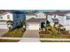Two-story house, paved driveway, and landscaping in a residential neighborhood at 1166 Aloha Blvd, Davenport, FL 33897