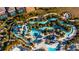 Large resort-style pool with lazy river and water slides from above at 1166 Aloha Blvd, Davenport, FL 33897