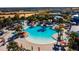 Large pool with surrounding lounge chairs and palm trees at 1166 Aloha Blvd, Davenport, FL 33897