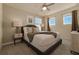 Comfortable bedroom with a queen bed, large windows, and a ceiling fan at 1166 Aloha Blvd, Davenport, FL 33897