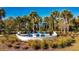 Circular fire pit with blue chairs in landscaped area at 1166 Aloha Blvd, Davenport, FL 33897