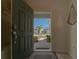 Open door revealing a walkway and neighborhood view at 1166 Aloha Blvd, Davenport, FL 33897