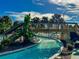 Relaxing lazy river pool with a wooden footbridge and lush foliage at 1166 Aloha Blvd, Davenport, FL 33897