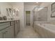 Main bathroom with soaking tub and walk-in shower at 1166 Aloha Blvd, Davenport, FL 33897