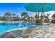 Luxury lounge chairs under a turquoise umbrella next to the resort pool at 1166 Aloha Blvd, Davenport, FL 33897