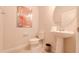 Stylish powder room with pedestal sink and toilet at 1166 Aloha Blvd, Davenport, FL 33897