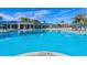 Large resort-style pool with plenty of lounge chairs and umbrellas at 1166 Aloha Blvd, Davenport, FL 33897