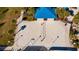 Aerial view of a community sand volleyball court with a net and surrounding landscaping at 1166 Aloha Blvd, Davenport, FL 33897