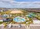 Aerial view of community pool, water park, and surrounding homes at 9327 Sommerset Hills Dr, Davenport, FL 33896