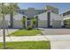 Modern townhome with two-car garage and well-manicured lawn at 9327 Sommerset Hills Dr, Davenport, FL 33896