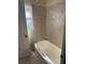Bathroom with beige tile and bathtub at 2331 Olney Rd, Lakeland, FL 33801