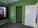 Bedroom with green walls, carpet, and a closet at 2331 Olney Rd, Lakeland, FL 33801