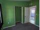Green-walled bedroom with closet and access to another room at 2331 Olney Rd, Lakeland, FL 33801