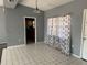 Dining area with tile floor and patterned curtains at 2331 Olney Rd, Lakeland, FL 33801