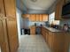 Galley kitchen with wood cabinets and granite counters at 2331 Olney Rd, Lakeland, FL 33801