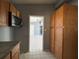 Kitchen with wood cabinets and view to adjacent room at 2331 Olney Rd, Lakeland, FL 33801