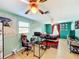 Fun bedroom with a gaming setup and teal walls at 151 Pine St, Babson Park, FL 33827