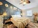 King-size bed, ceiling fan, and window with blinds in this relaxing bedroom at 151 Pine St, Babson Park, FL 33827