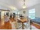 Bright dining room with a rustic farmhouse table and hardwood floors at 151 Pine St, Babson Park, FL 33827