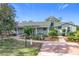 Ranch style home with a green exterior, landscaping, and a long driveway at 151 Pine St, Babson Park, FL 33827