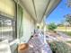 Side view of the front porch with stone flooring and lush landscaping at 151 Pine St, Babson Park, FL 33827