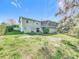 Back of house with large yard, screened porch, and detached storage at 151 Pine St, Babson Park, FL 33827