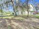 Side view of house showing large yard and mature trees at 151 Pine St, Babson Park, FL 33827