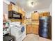 Small kitchen with white appliances and wood cabinets at 151 Pine St, Babson Park, FL 33827