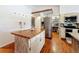 Kitchen island with butcher block countertop and white cabinets at 151 Pine St, Babson Park, FL 33827