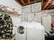 Basement laundry room with washer, dryer, and storage shelves at 151 Pine St, Babson Park, FL 33827