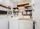Laundry room with washer, dryer, and ample storage shelving at 151 Pine St, Babson Park, FL 33827