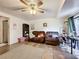Living room with tiled floors, ceiling fan, and comfortable seating at 151 Pine St, Babson Park, FL 33827