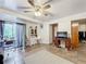 Open living area with tiled floors, a ceiling fan, and access to other rooms at 151 Pine St, Babson Park, FL 33827