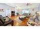 Spacious living room featuring hardwood floors, a fireplace, and ample seating at 151 Pine St, Babson Park, FL 33827